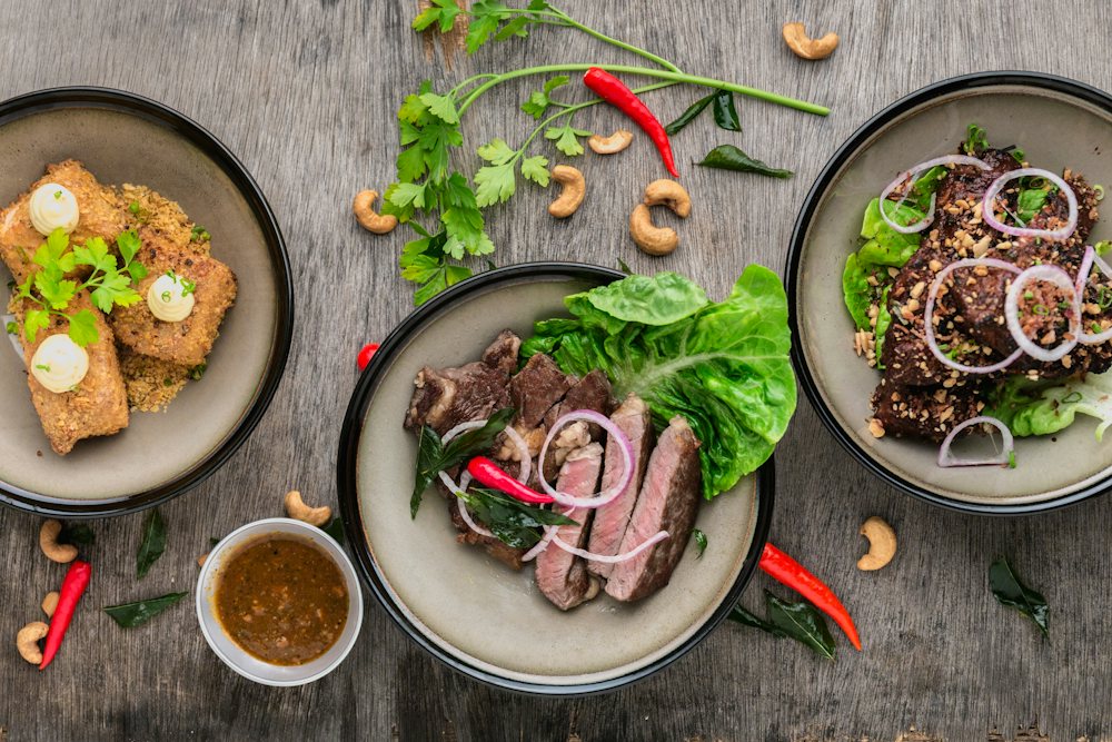 Shared plates of local food on a wooden table