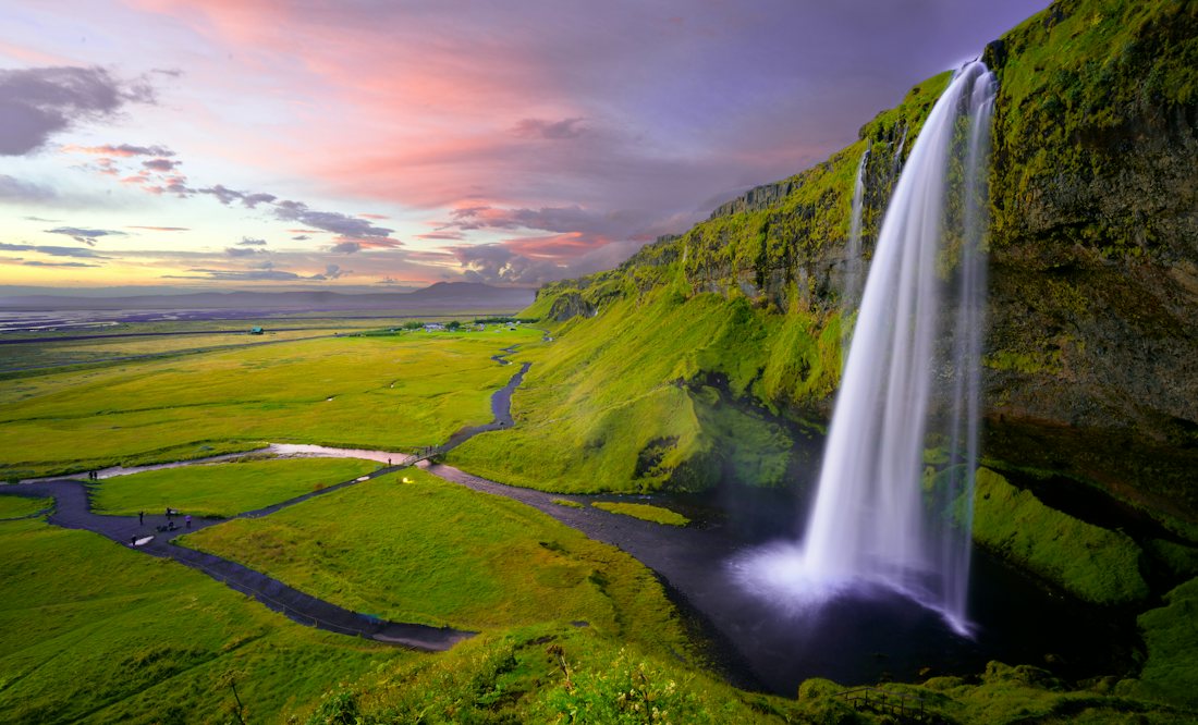 Seljalandsfoss waterfall over green fields